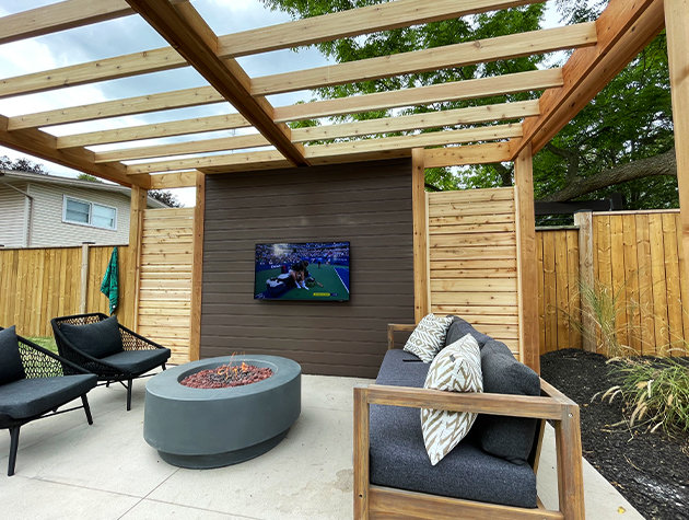 Poolside pergola with outdoor furniture and a television